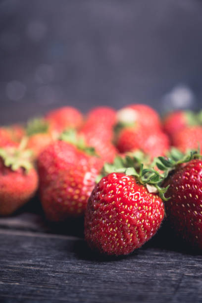 istock Ripe and juicy strawberries on the dark rustic background 1162483202