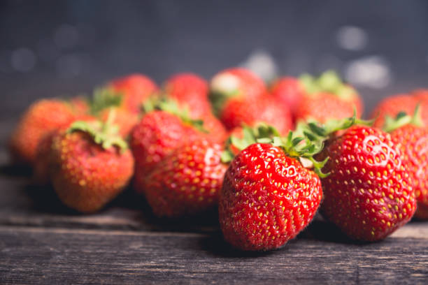 istock Ripe and juicy strawberries on the dark rustic background 1162483204