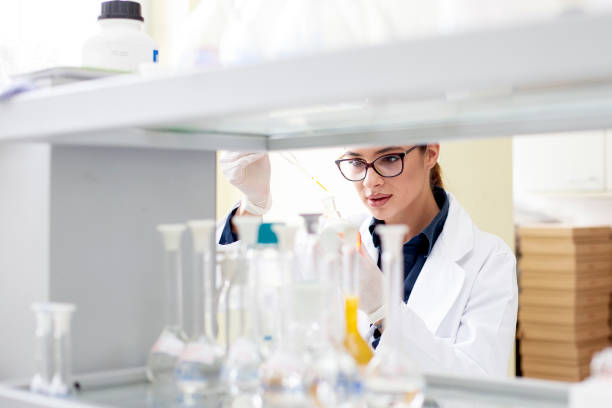 istock Young woman working in laboratory on some experiment 1162484317