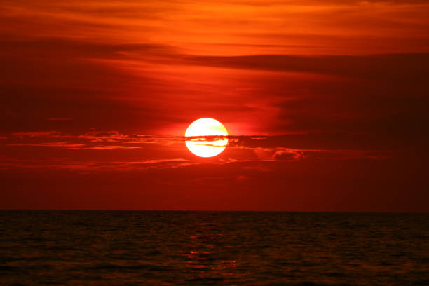 istock sun back on sunset sky horizon wave on surface sea 1162489717