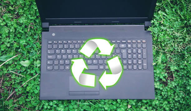 istock Black laptop with Recycle sign in the grass. 1162490586