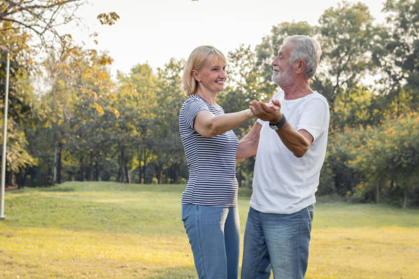 istock Senior couples dance together in the park. 1162492481