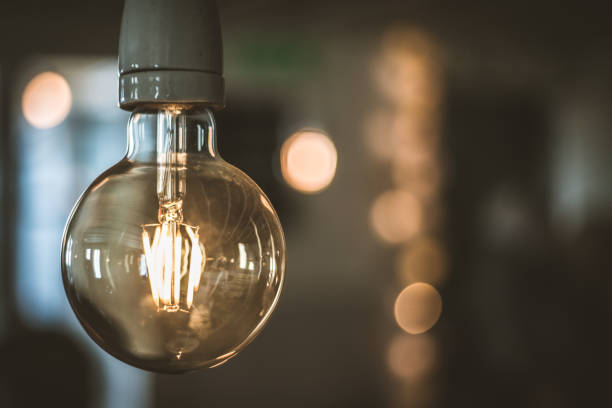 istock Old vintage light bulb with blurred background in the cafe 1162492692