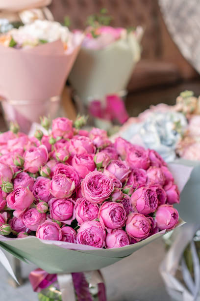 istock Vases with different colored flowers, showcase flower shop. Beautiful spring bouquets. . Small family business. Work florist. copy space 1162493448