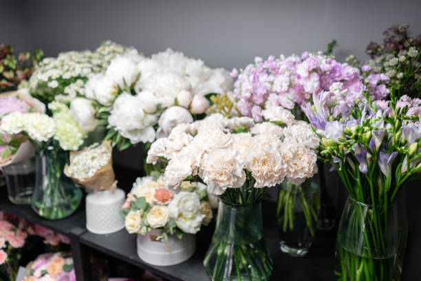 istock Vases with different colored flowers, showcase flower shop. Beautiful spring bouquets. . Small family business. Work florist. copy space 1162493751