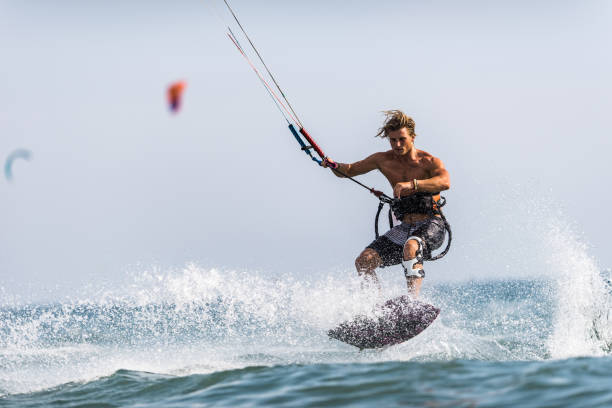 istock Athletic man having fun while kitesurfing on the sea. 1162493921