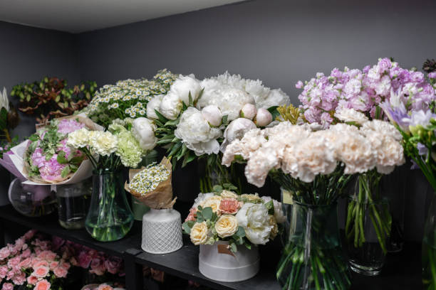istock Vases with different colored flowers, showcase flower shop. Beautiful spring bouquets. . Small family business. Work florist. copy space 1162494516
