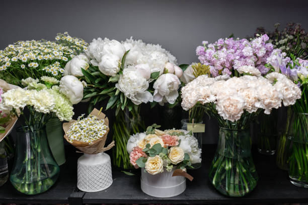 istock Vases with different colored flowers, showcase flower shop. Beautiful spring bouquets. . Small family business. Work florist. copy space 1162494522