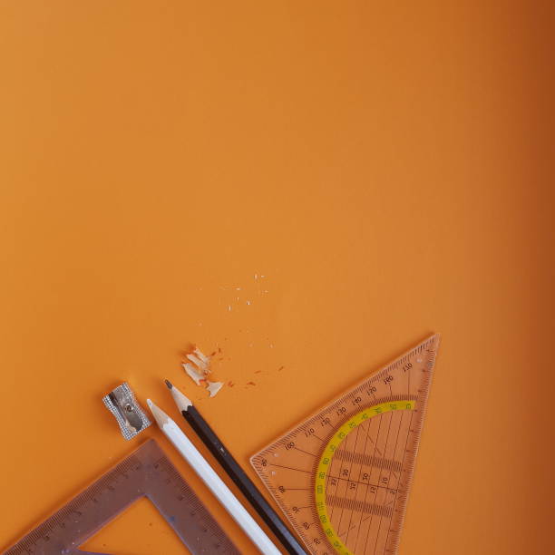 istock sharpener for color pencils, pencils on an orange background ready for work, flat photography 1162494806