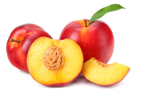 istock Nectarine with green leaf and slices isolated on white background 1162495266