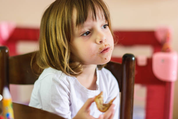 istock Little girl eating toast with jam. 1162497717