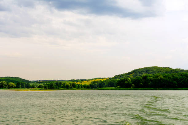 istock landscape green meadow , wide river and cloudy sky before the rain 1162500163