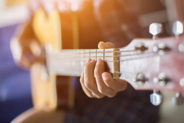 istock Beautiful woman playing guitar 1162500182