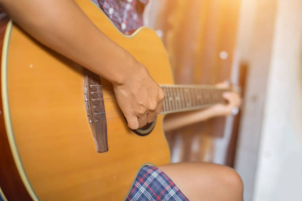 istock Beautiful woman playing guitar 1162500209