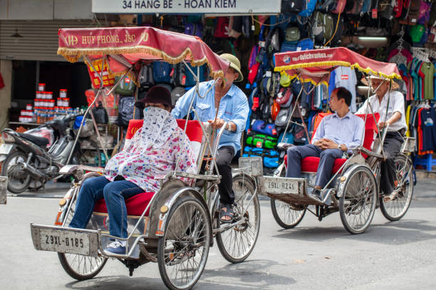 The Old Quarter, The Hanoi Street, rickshaw in the streets of Vietnam Hanoi, Vietnam - june 16, 2019: The Old Quarter, The Hanoi Street, rickshaw in the streets of Vietnam vietnamese man taxi motorbike driver stock pictures, royalty-free photos & images