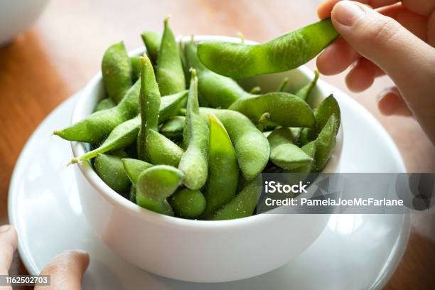 Pov Salted Edamame Beans Eating Japanese Food By Hand Stock Photo - Download Image Now