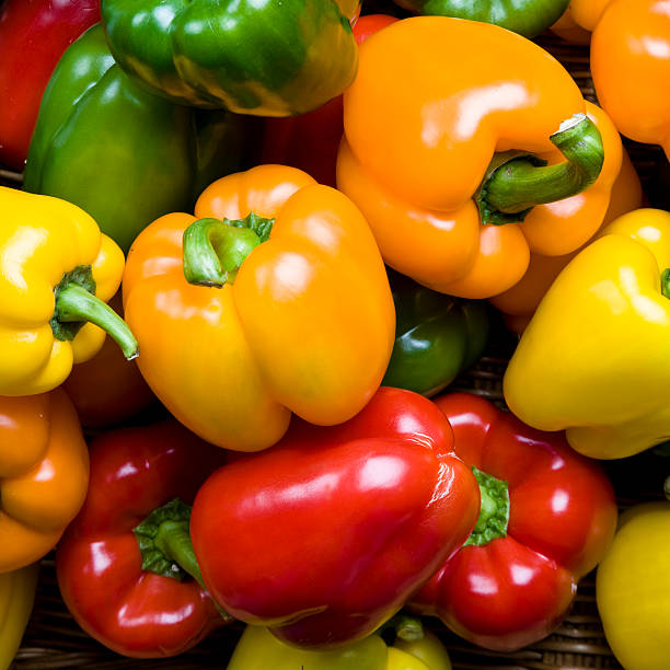 istock Red green yellow and orange peppers as a background 116250271