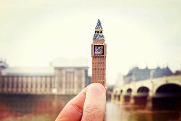 istock man holding the Clock Tower in London, UK 1162503359
