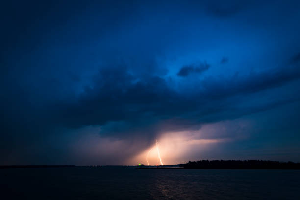 istock Lightning in the dark night sky over a lake during summer 1162504311