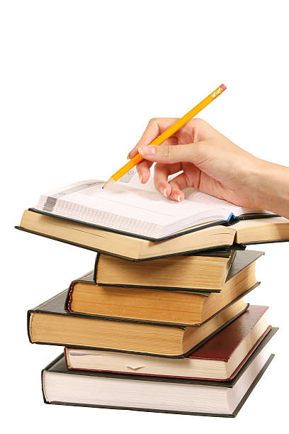 istock books and woman hand writes in a notebook 116250556