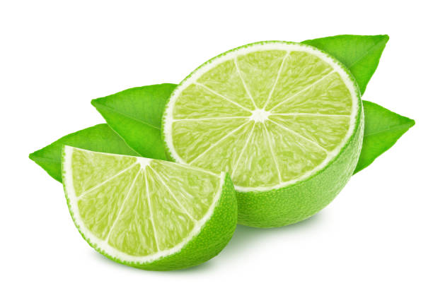 istock Half and slice of lime with leaves isolated on white background. 1162507295