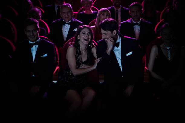 istock Couple laughing while enjoying opera amidst crowd 1162509479