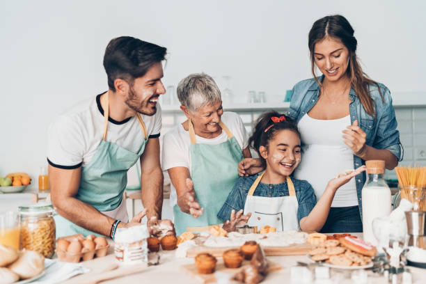 istock Multi-generation family preparing cookies together 1162510342