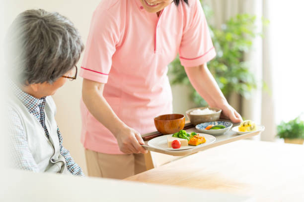 istock Caregiver preparing a meal 1162510515