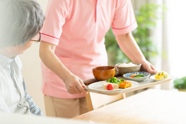 istock Caregiver preparing a meal 1162510516