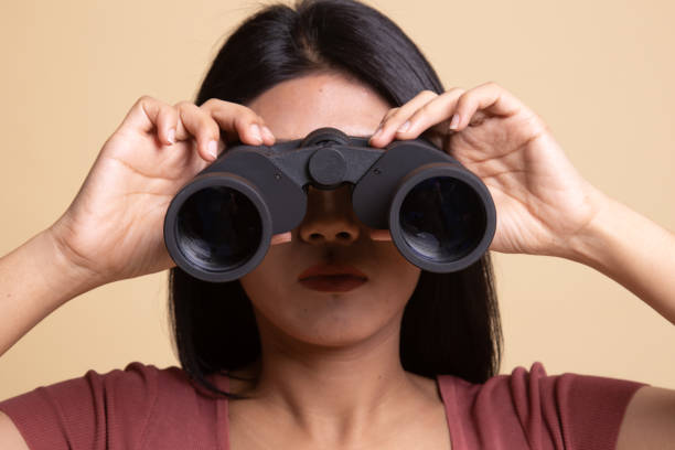 istock Young Asian woman with binoculars. 1162510575
