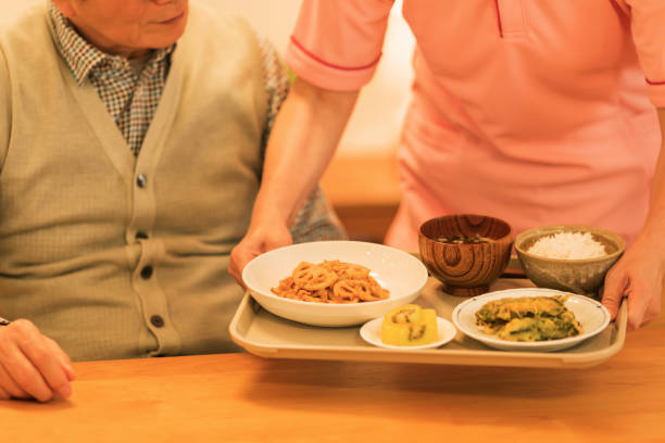 istock Caregiver preparing a meal 1162510602