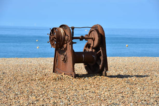 Rusty old fishing winch on Brighton beach in summer.
