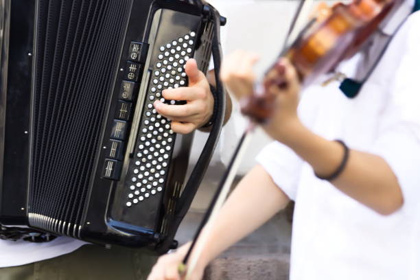 Young Man Playing on Accordion on Street