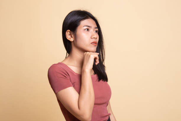 istock Serious  young Asian woman  look away. 1162512741