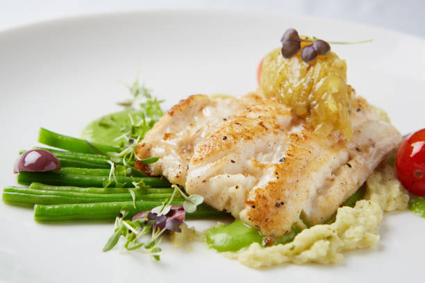 istock Grilled fish with green beans in fine dining restaurant 1162513090