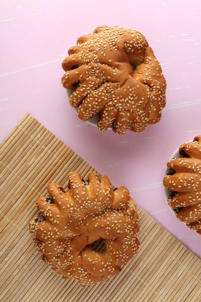 istock Bakery - gold rustic crusty loaves of bread and buns on textured background. 1162513155