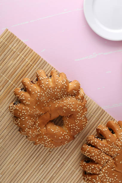 istock Bakery - gold rustic crusty loaves of bread and buns on textured background. 1162513710