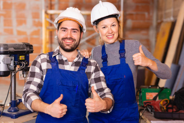 istock Portrait of two successful workers in uniform inside brick cottage 1162513786