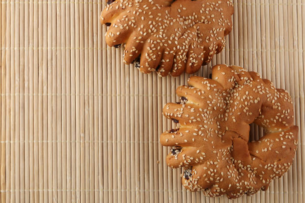 istock Bakery - gold rustic crusty loaves of bread and buns on textured background. 1162513834