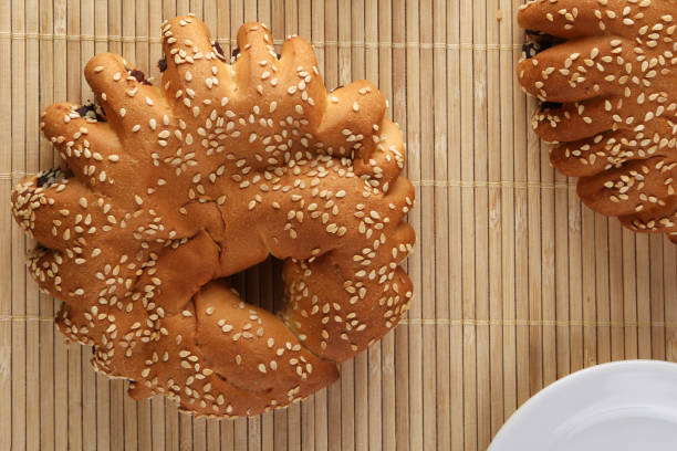 istock Bakery - gold rustic crusty loaves of bread and buns on textured background. 1162513892
