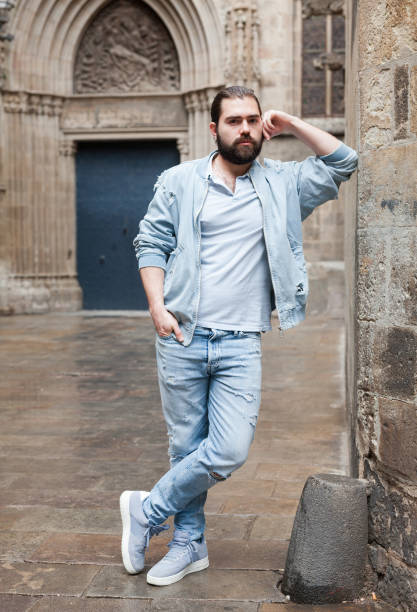 istock Handsome adult man with a beard in a jeans jacket 1162513899