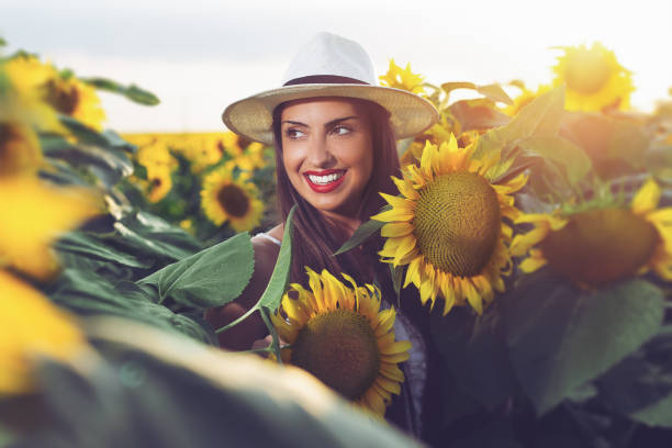 istock Woman With Hat in a Sunflower Field 1162513920