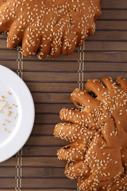 istock Bakery - gold rustic crusty loaves of bread and buns on textured background. 1162513921