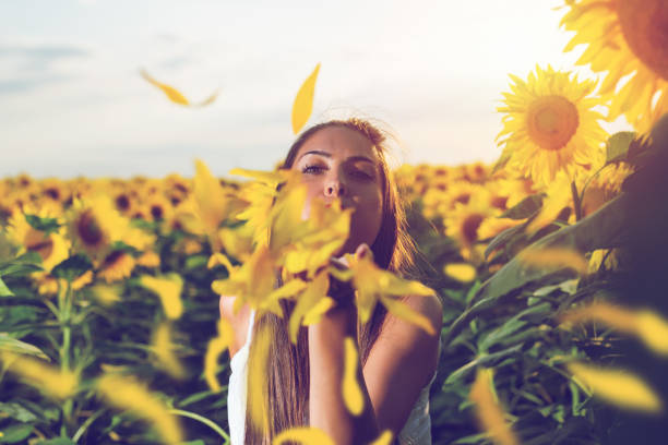 istock Woman enjoys in sunflower field 1162514169