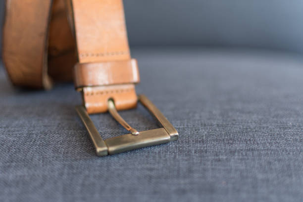 istock Leather men's belt on a blue fabric background. 1162514183