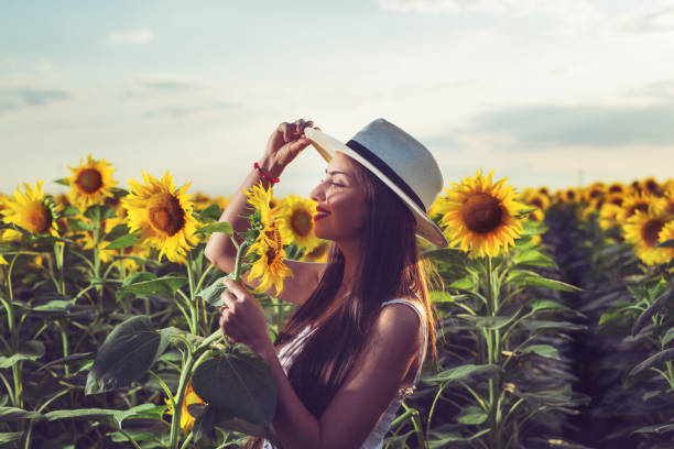 istock Woman enjoys in sunflower field 1162514645