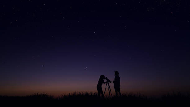 istock Young people observing the night sky 1162515813