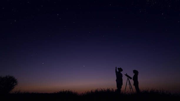 istock Young people observing the night sky 1162515815