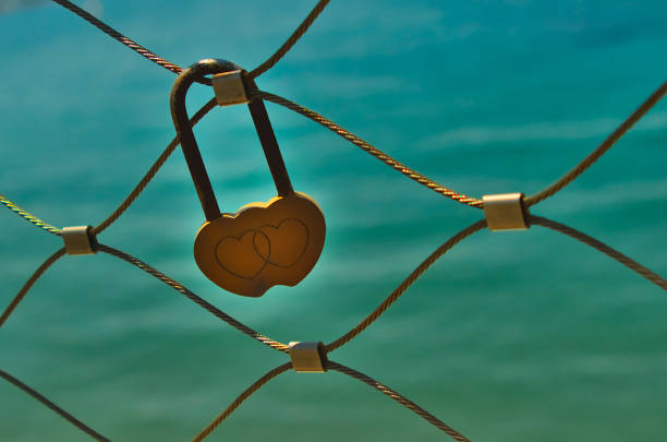 serrure jaune d'amour sur la balustrade de pont - eternity love stone heart shape photos et images de collection