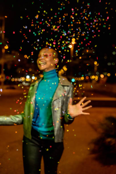 istock Cool woman under a rain of confetti 1162516332